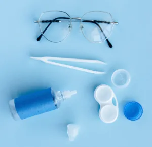 Photo of contact lenses, glasses, and eye drops.